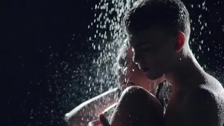 Picture of a man and a woman taking a shower against a dark background