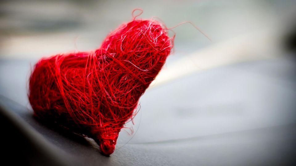 A picture of a heart made using read thread